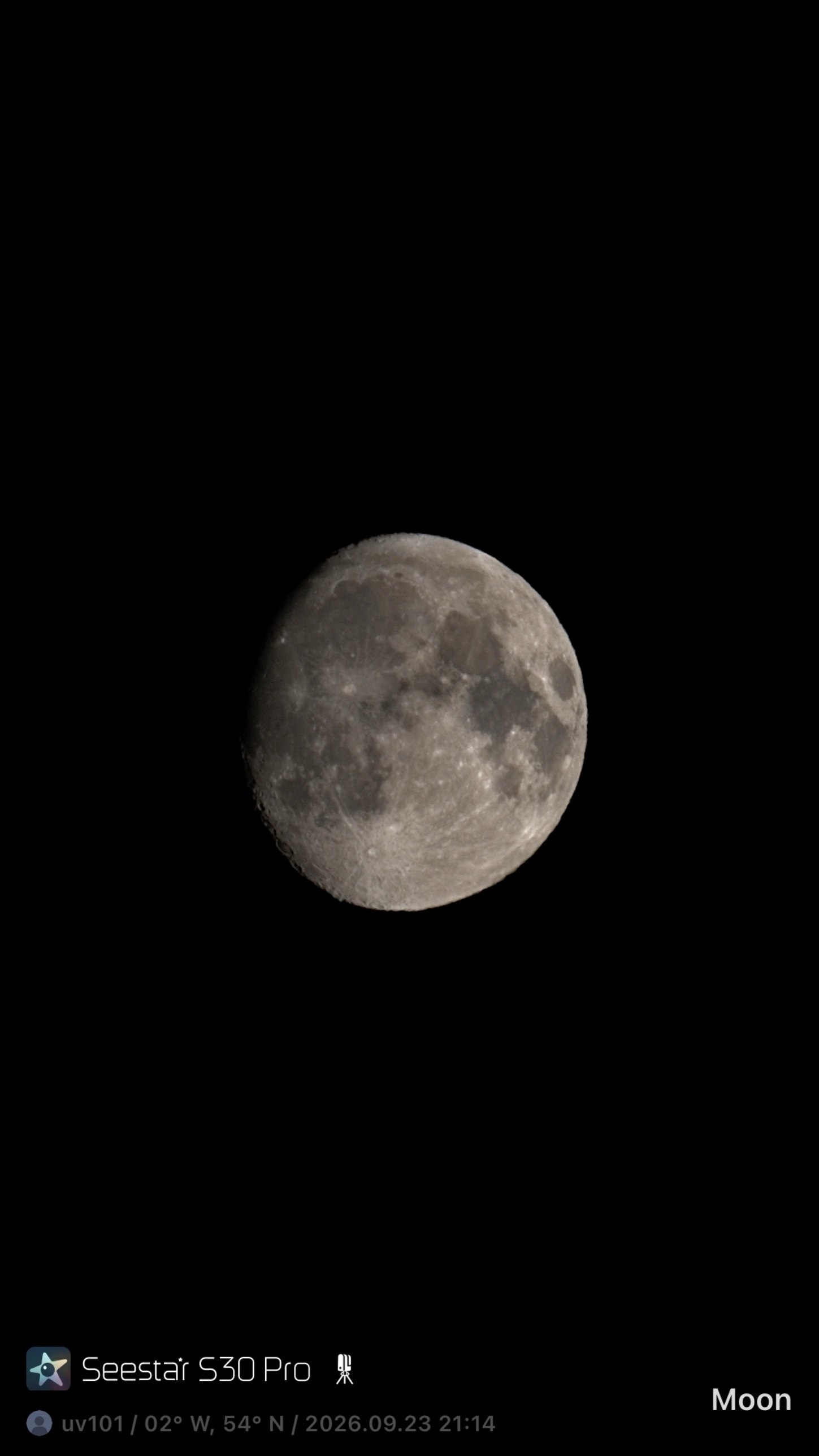 Waxing gibbous Moon, small in the frame, with craters and maria visible